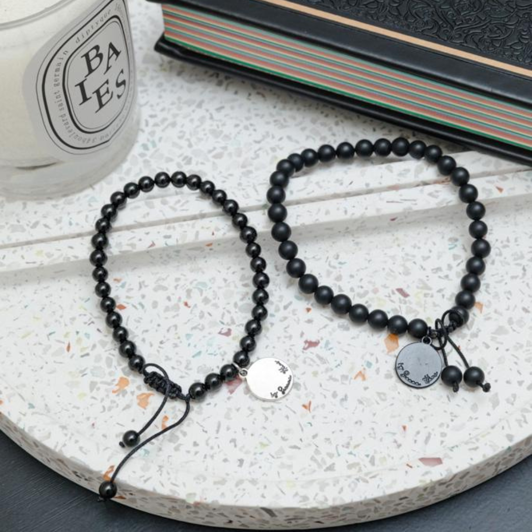 White bead bracelet sales with one black bead